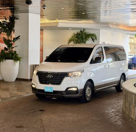 SupAce Transfers private transfer van waiting at an Aruba resort entrance for a hotel pickup